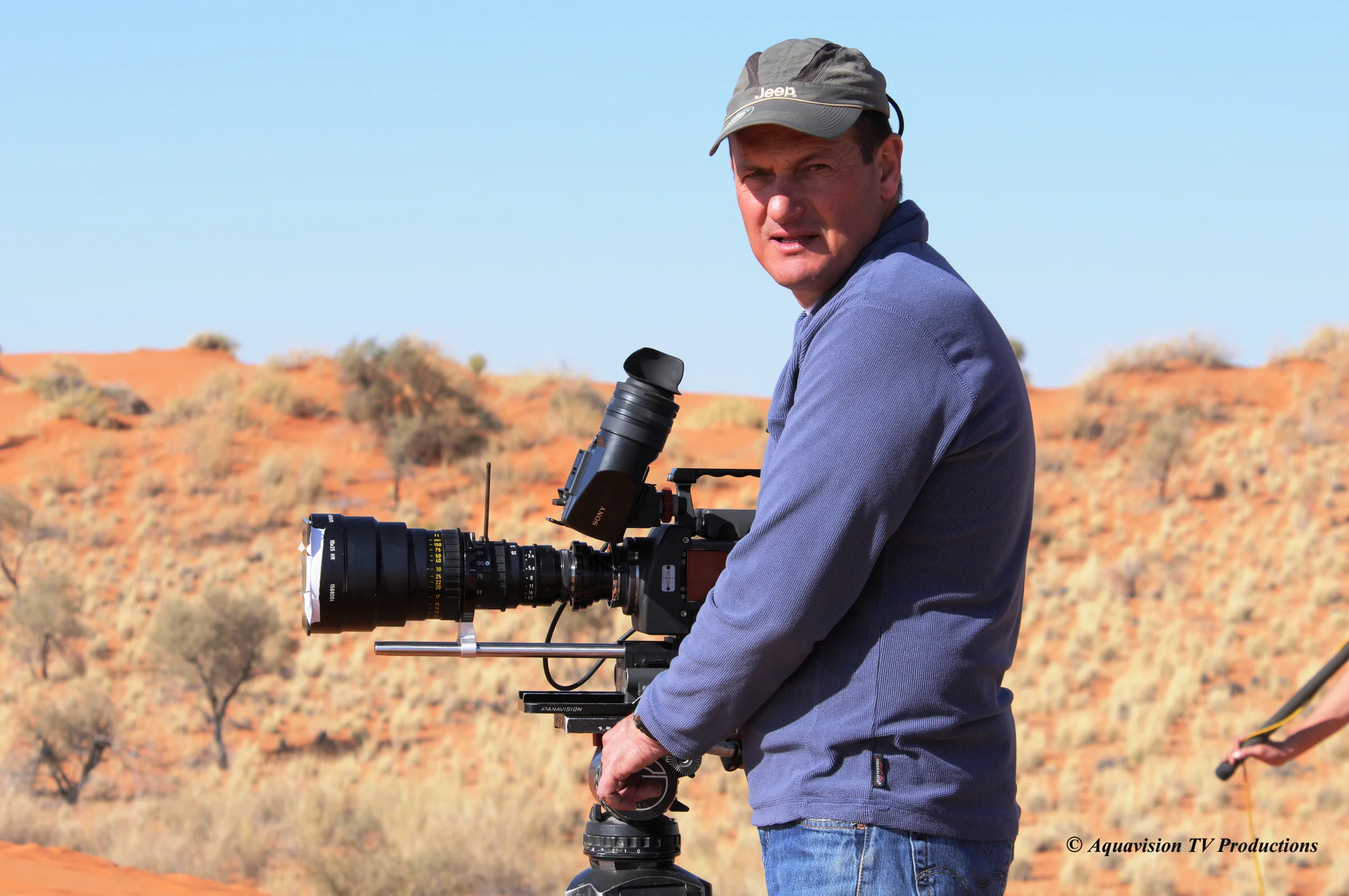Aquavision camera operator with a cinema camera in the Kalahari